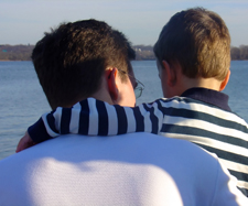 child with his hand around his father