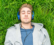 male is listening to music on his headphones