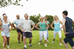 Colleagues stretching together outside
