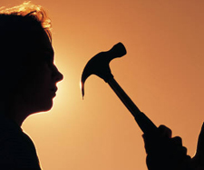 silhouette of young male holding hammer