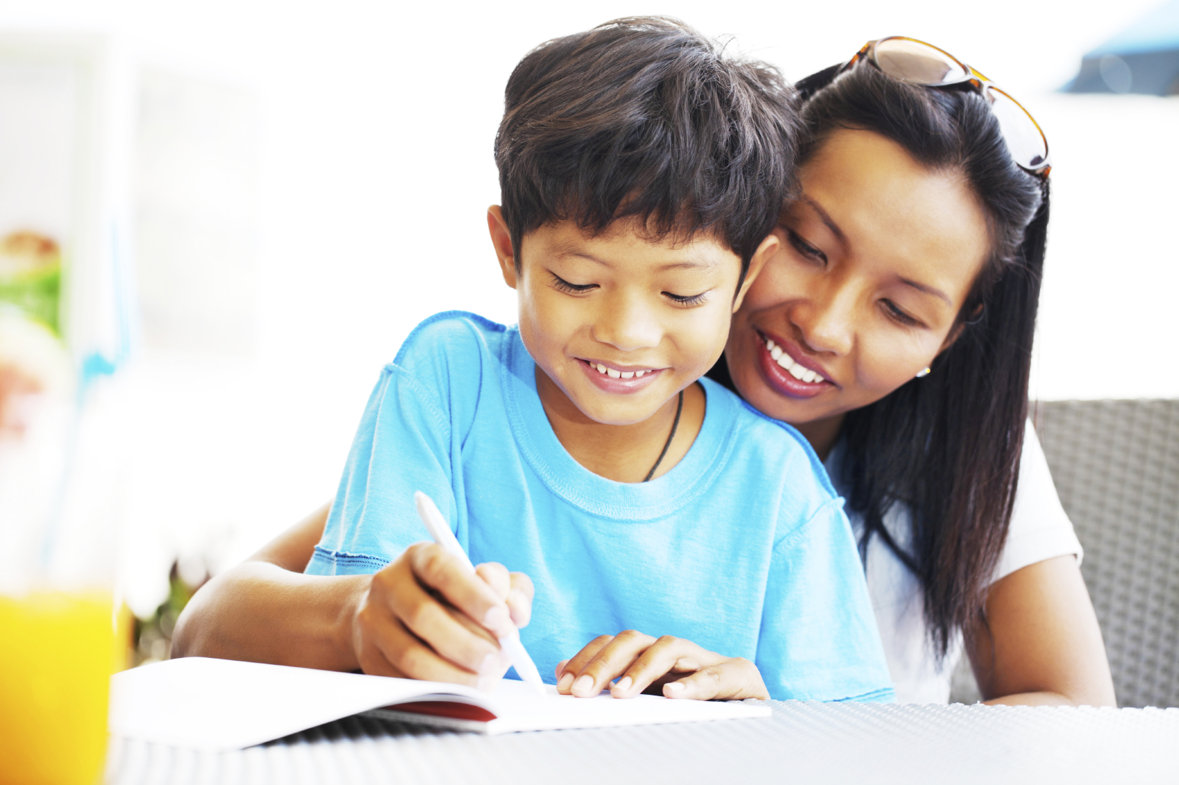 mother is helping her child with his homework
