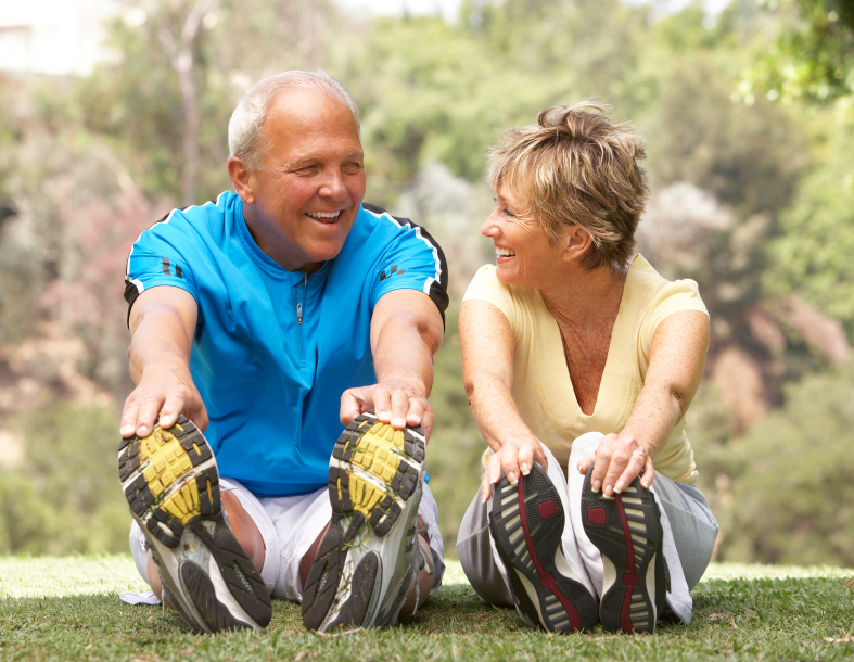 old couple is stretching outdoors